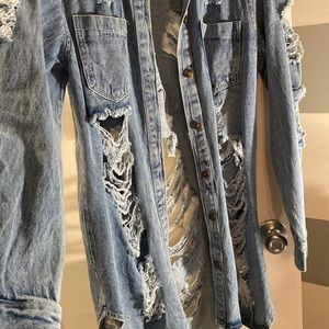Distressed long jean jacket, Medium - Dark wash. Has two pockets. Size large